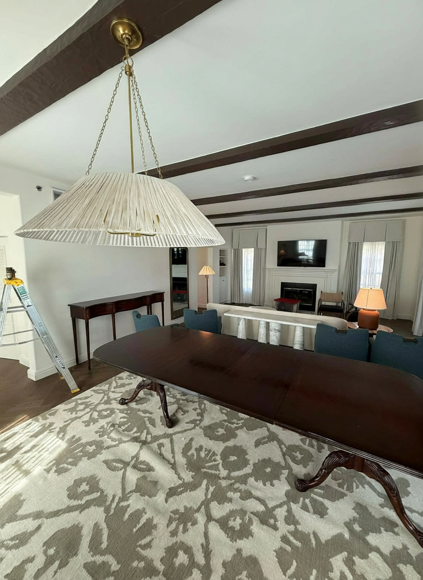 A chandelier glowing in a finished home